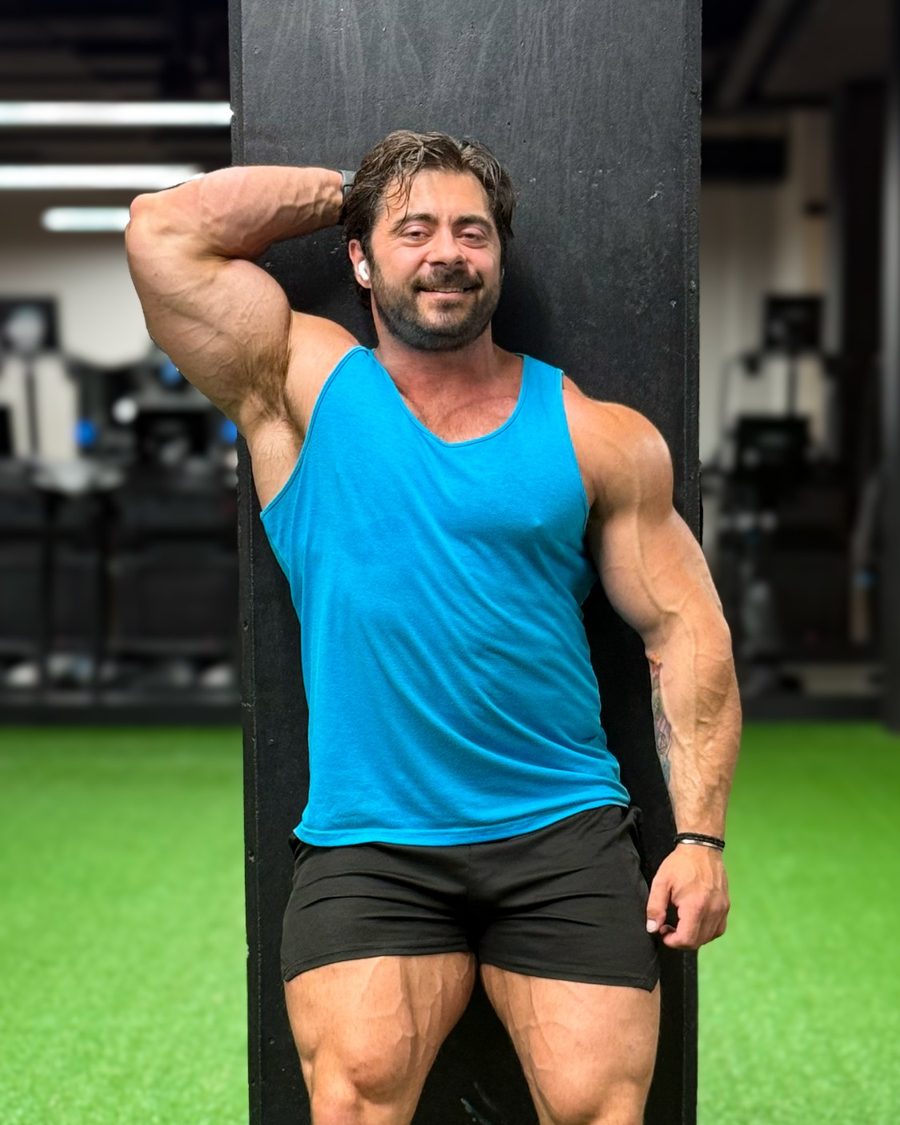 Derek Bolt smiling, leaning against a pillar in the gym